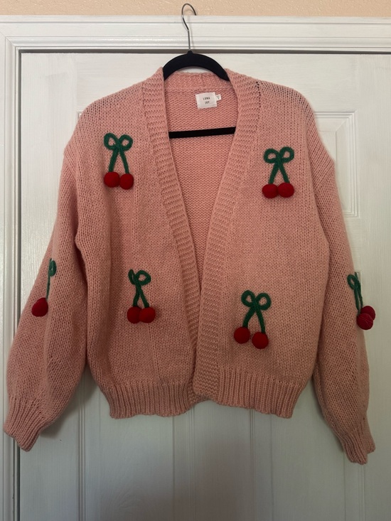 Luna Ivy Sweaters - Pink Luna Ivy cardigan featuring prominent green and red 3D cherry appliqués.